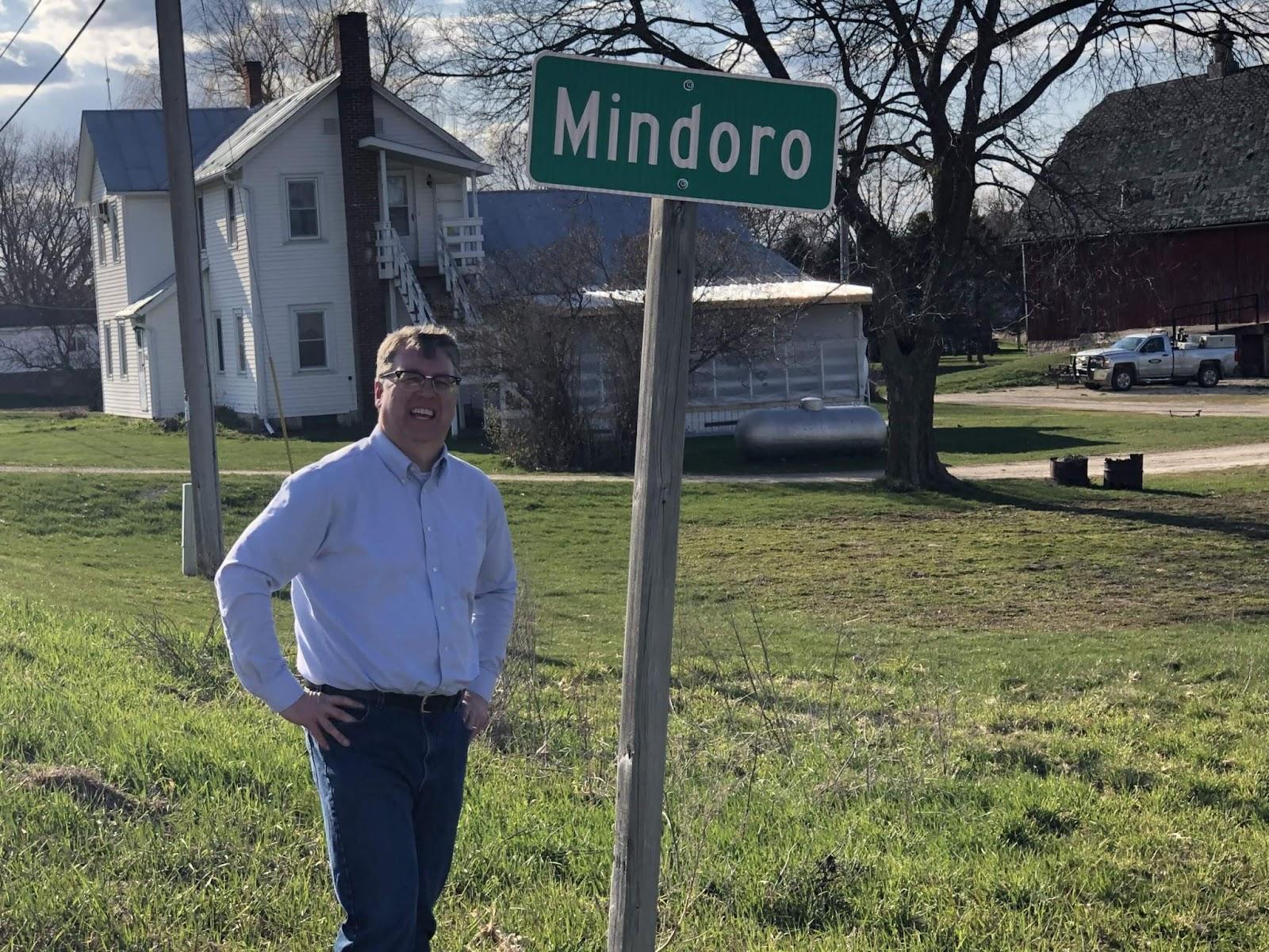 Photo of Brad Pfaff standing next to a sign