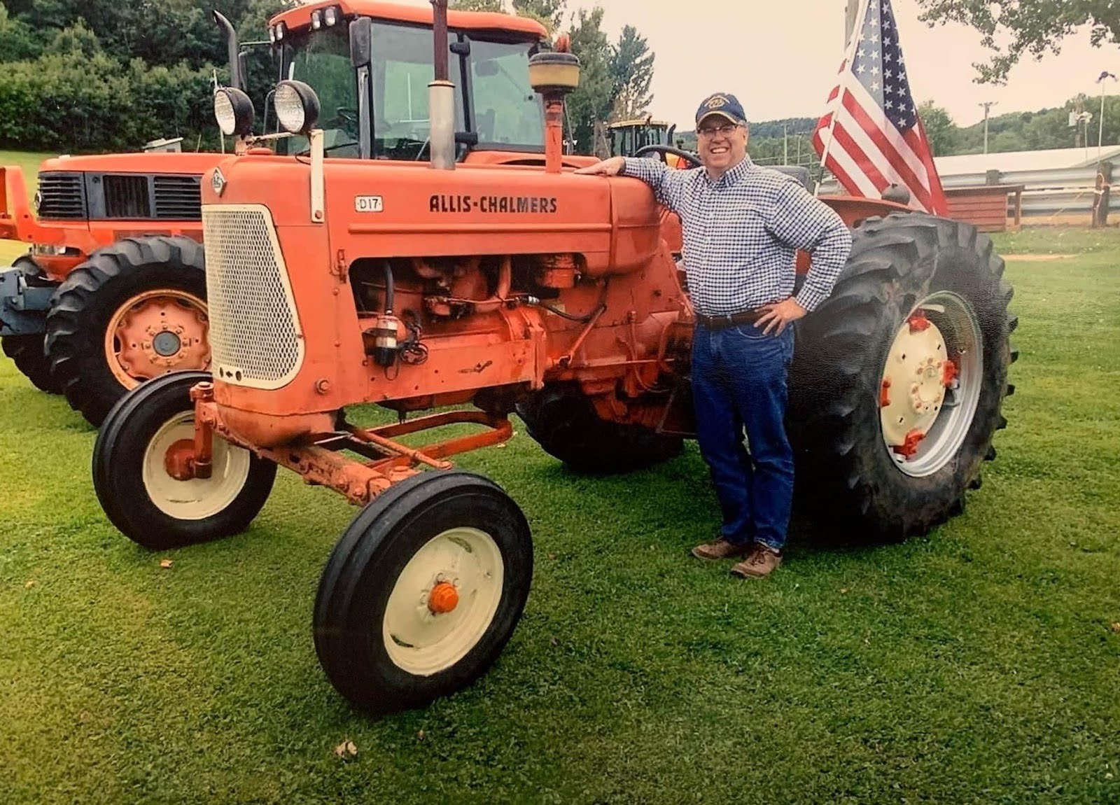Photo of Brad Pfaff standing next to a tractor