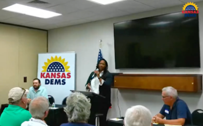 Jeanna Repass, standing at the front of a room full of people