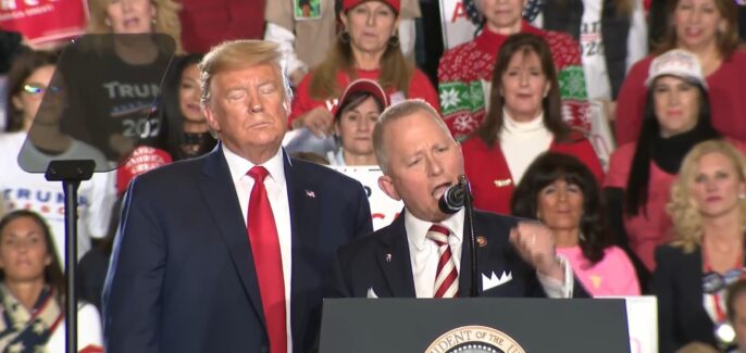 Donald Trump standing over Jeff Van Drew speaking at rally